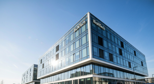 A photorealistic image of the BioNTech headquarters in Mainz, Germany, with a modern glass building and the company logo, under a clear blue sky, conveying a sense of corporate power and innovation.